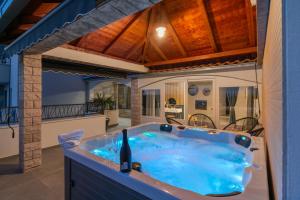 a bath tub with a bottle of wine in it at Luxury Dream House Nea with jacuzzi in Makarska