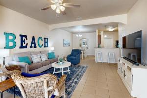 a living room with a couch and a table at Feelin' Beachy in Padre Island