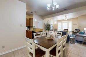 a dining room and kitchen with a table and chairs at Feelin' Beachy in Padre Island