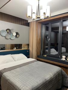 a bedroom with a large bed and a mirror at Four Sisters Luxury Rooms in Siauliai in Šiauliai