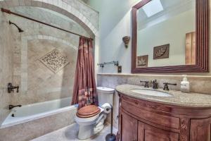 a bathroom with a tub and a toilet and a sink at Blackfoot Luxury Retreat - Hot Tub Pool Table Pets Deck in South Lake Tahoe +21 photos