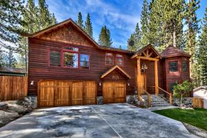 a log home with a garage at Blackfoot Luxury Retreat - Hot Tub Pool Table Pets Deck in South Lake Tahoe