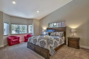 a bedroom with a bed and two red chairs at Blackfoot Family Estate in South Lake Tahoe +25 photos
