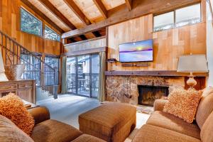 a living room with a fireplace and a tv at Lakeland Village 480 - Remodeled Close to Skiing 2BRLoft in South Lake Tahoe