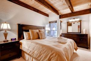 a bedroom with a large bed and a mirror at Lakeland Village 480 - Remodeled Close to Skiing 2BRLoft in South Lake Tahoe +31 photos