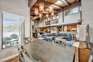 a dining room and living room with a table and chairs at Lakeland Village 603 Lakeview - See Ski Tahoe-Steps to Lake in South Lake Tahoe