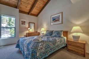 a bedroom with a bed and a window at Lakeland Village 603 Lakeview - See Ski Tahoe-Steps to Lake in South Lake Tahoe +10 photos