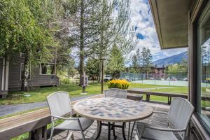 a patio with a table and chairs and a view of a park at Lakeland Village 603 Lakeview - See Ski Tahoe-Steps to Lake in South Lake Tahoe