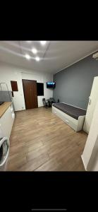 a large room with a bed and a tv in it at HOUSE SAN FILIPPO in Naples