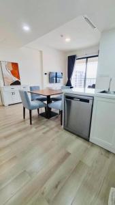 a kitchen and dining room with a table and chairs at Nicole House in Gò Công
