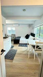 a bedroom with a bed and a desk and a table at Modern Studio Stylish &Cozy Back Unit in Los Angeles