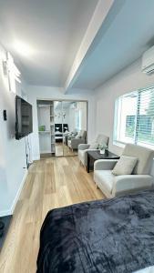 a large living room with a couch and a tv at Modern Studio Stylish &Cozy Back Unit in Los Angeles +22 photos