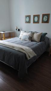 a large bed in a bedroom with two clocks on the wall at Totem in Mar del Plata