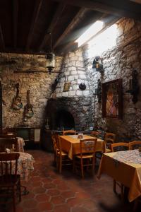 a dining room with tables and a stone fireplace at Mesón de la Abundacia in Real de Catorce