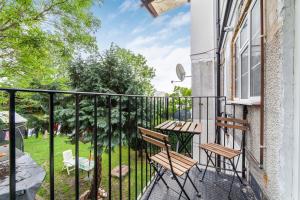 a balcony with two chairs and a table at Arte Stays - New & Spacious 2 Bedroom Flat - close by Wembley Stadium - Parking in London