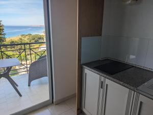a kitchen with a view of the ocean from a balcony at Vivenda Solmar in Lagos