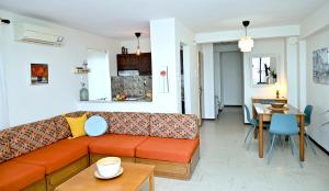 a living room with a couch and a table at Summer Jam in Paralia Katerinis