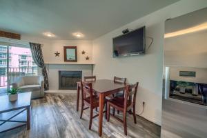 a living room with a table and a fireplace at Grandmas River Haus RRC A108 in New Braunfels