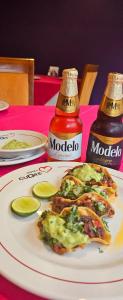 a plate of food on a table with a bottle of salsa at Novo Coapa in Mexico City