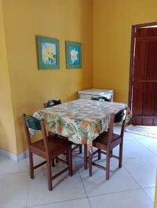 a dining room table with chairs and a table and a table and chairsktop at Casa Portal in Paraty