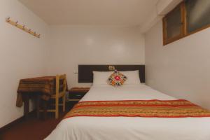 Postel nebo postele na pokoji v ubytování Lucios Cusco
