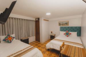 Postel nebo postele na pokoji v ubytování Lucios Cusco