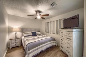 a bedroom with a bed and a flat screen tv at CRC 317 Timeless Tranquility in New Braunfels