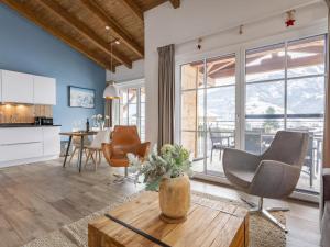 a kitchen and living room with a table and chairs at Luxury Tauern Suite Walchen-Kaprun 3 in Piesendorf