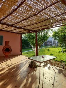 a patio with a wooden pergola and a table at Villa Naima in Larache