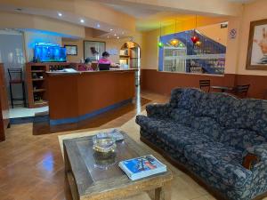 a living room with a couch and a bar at Hotel Maria Luisa in Huajuapan de León