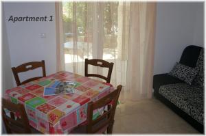 a dining room with a table with a box on it at Apartment Lopar 14804a in Lopar