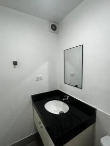 a bathroom with a sink and a mirror at Departamento familiar en el centro de Lima Perú in Lima