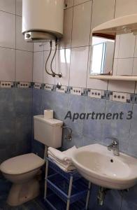 a bathroom with a toilet and a sink at Apartments with WiFi Lopar, Rab - 14804 in Lopar