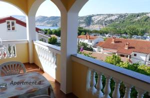 a balcony with a view of the water and mountains at Apartments with WiFi Lopar, Rab - 14804 in Lopar