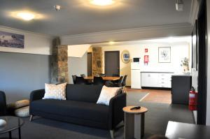 a living room with a couch and a table at Snowy Gums Smiggins in Perisher Valley
