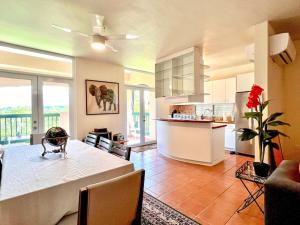 a kitchen and living room with a table and a counter at Villa Mango in North Coast in Dorado