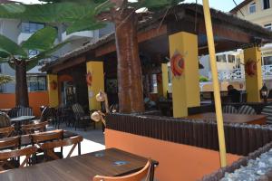 a restaurant with tables and chairs on a patio at Noo 15 in Side