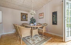 a dining room with a table and chairs at Three-Bedroom Holiday Home In Hornbak in Hornbæk