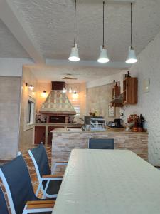 a kitchen with a table and chairs and a stove at Villa Naima in Larache