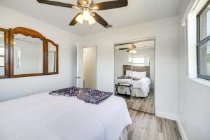 a white bedroom with a bed and a ceiling fan at Melbourne Vacation Rental about 5 Mi to Beaches! in Melbourne