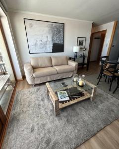 a living room with a couch and a coffee table at Valle Nevado Apartamento Ski In Out in Valle Nevado
