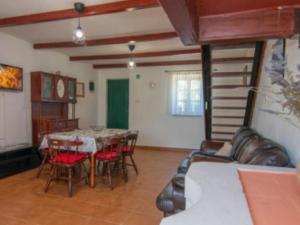 a dining room with a table and red chairs at Apartments with parking space Bonic, Losinj - 23056 in Veli Lošinj