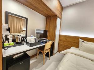 una camera con scrivania, computer e letto di Mungyeong Stay 201 Hotel a Mungyeong