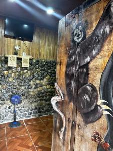 eine Wand mit einem Bild einer Schlange drauf in der Unterkunft Mochileros MarAbi in Tarcoles