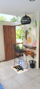 a room with a chair and a table and a door at Mecca in Puerto Viejo