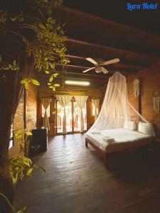 a bedroom with a bed with a mosquito net at Lura Bacalar in Bacalar +22 photos