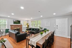 a living room with a table and a fireplace at Stately 5BR Historic Retreat CozySuites in Alexandria