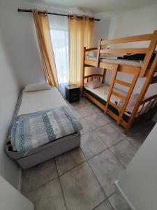 1 dormitorio con 2 literas y suelo de baldosa en Cabañas Herradura Oriente, en Coquimbo