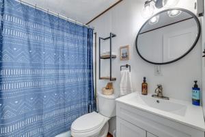 a bathroom with a white toilet and a blue shower curtain at Close to Locust Lake:Beach:Fire Pit:Kalahari in Locust Lakes Village +49 photos