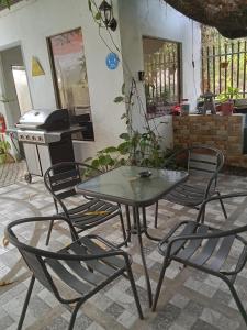 a table and chairs in a patio with a stove at YOO Darius' Residences in Moalboal